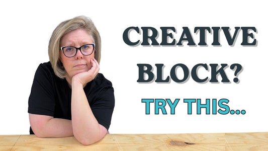 Maker leaning on a workbench with a thoughtful expression beside the headline "Creative Block? Try This."