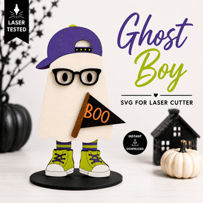 A Halloween-themed laser-cut design preview featuring a ghost boy character wearing a purple cap, black glasses, lime green sneakers, and holding a black flag that says 'BOO'. The image includes promotional text reading 'Ghost Boy', 'SVG for laser cutter', and 'Instant Download', along with decorative pumpkins and a house backdrop.