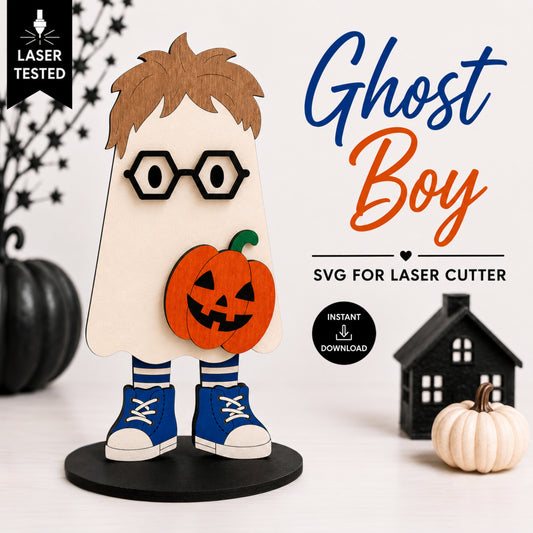 A Halloween-themed laser-cut design preview featuring a ghost boy character with brown hair, black glasses, an orange jack-o'-lantern, blue sneakers, and a cream ghost body on a black base. The image includes promotional text reading 'Ghost Boy', 'SVG FOR LASER CUTTER', 'Instant Download', and a 'Laser Tested' badge, with decorative pumpkins and a small house around the product.