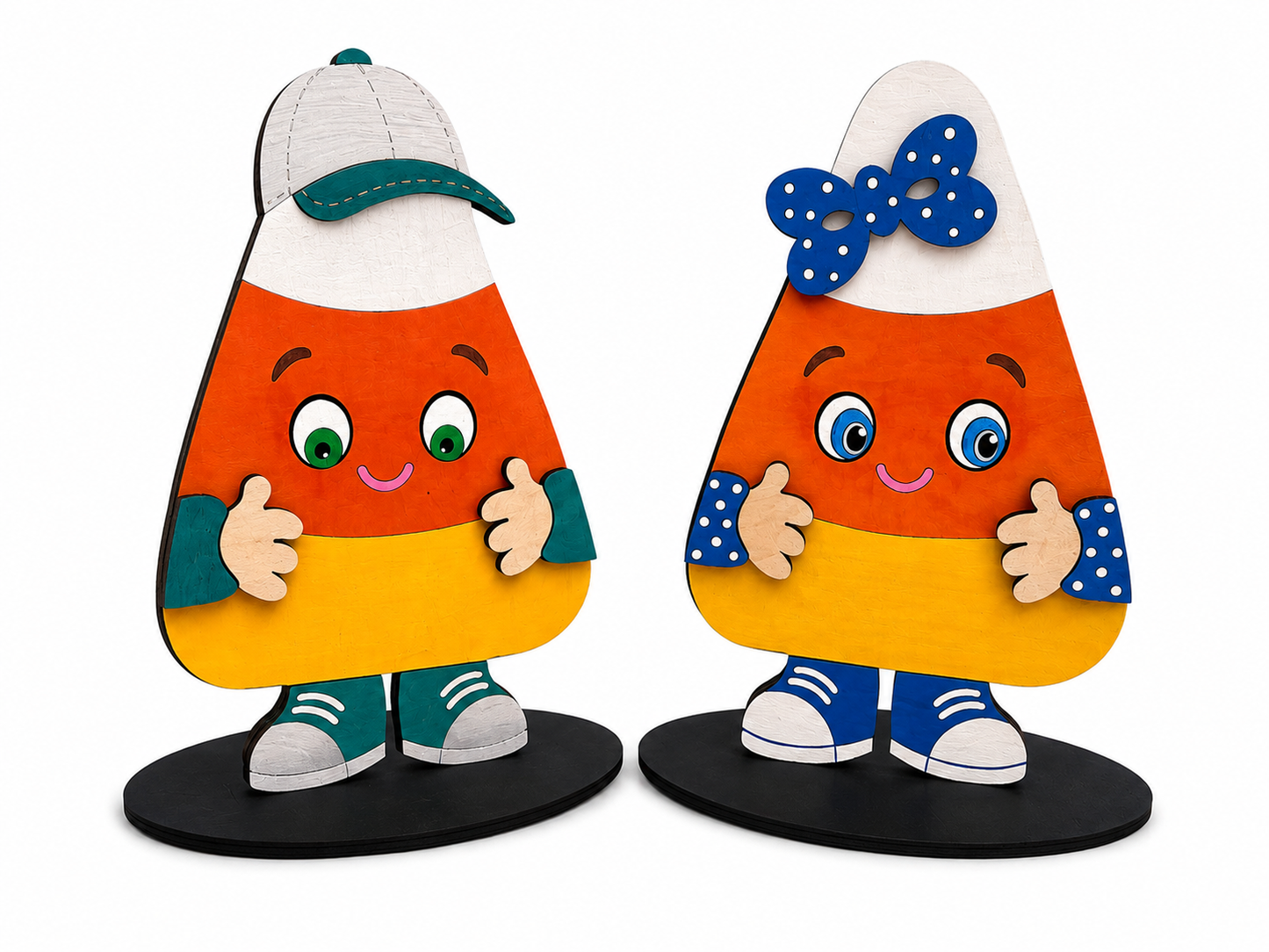 Two cute, handcrafted wooden candy corn figurines with smiling faces, standing on black circular bases against a white background.