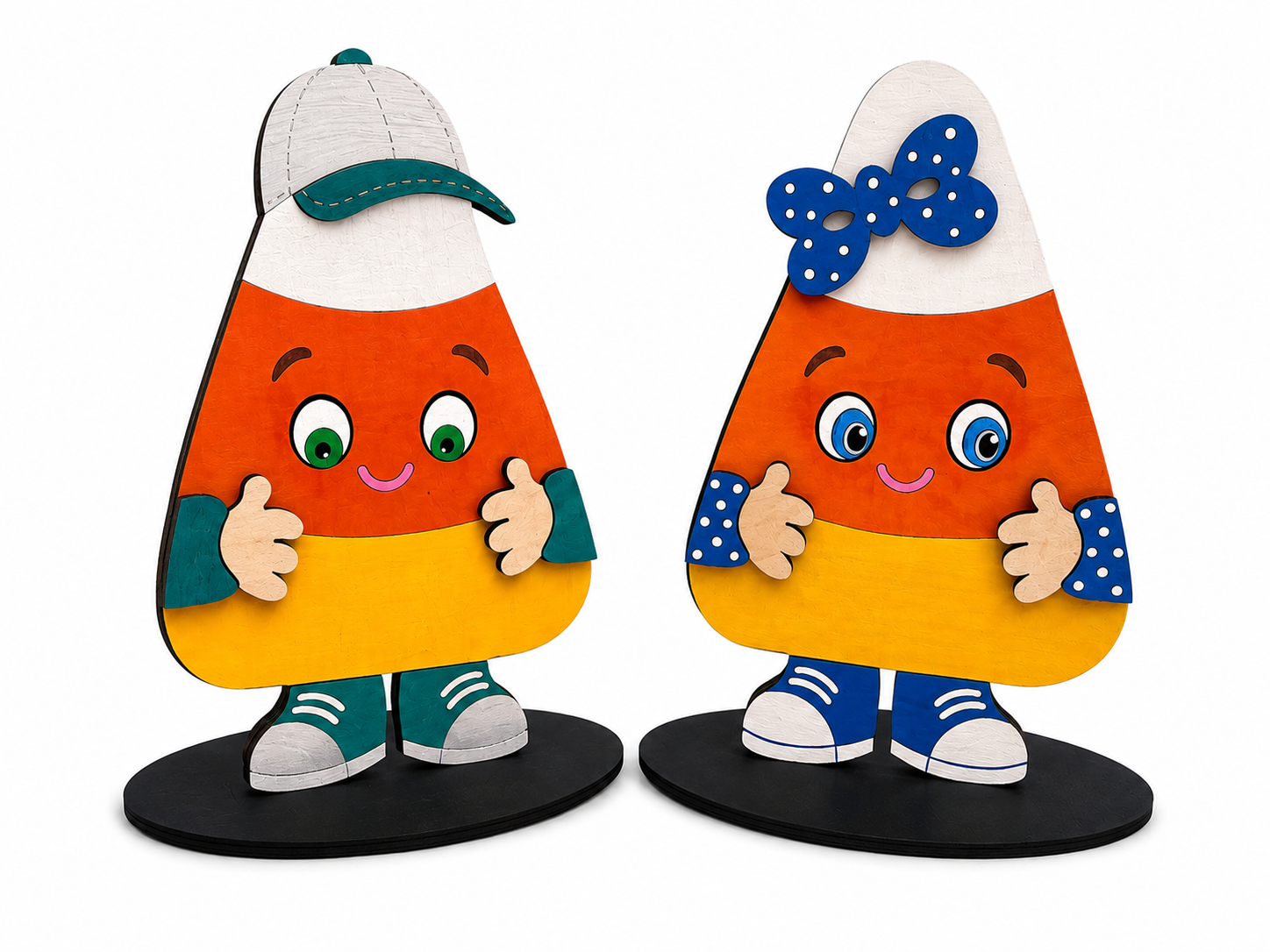 Two cute, handcrafted wooden candy corn figurines with smiling faces, standing on black circular bases against a white background.