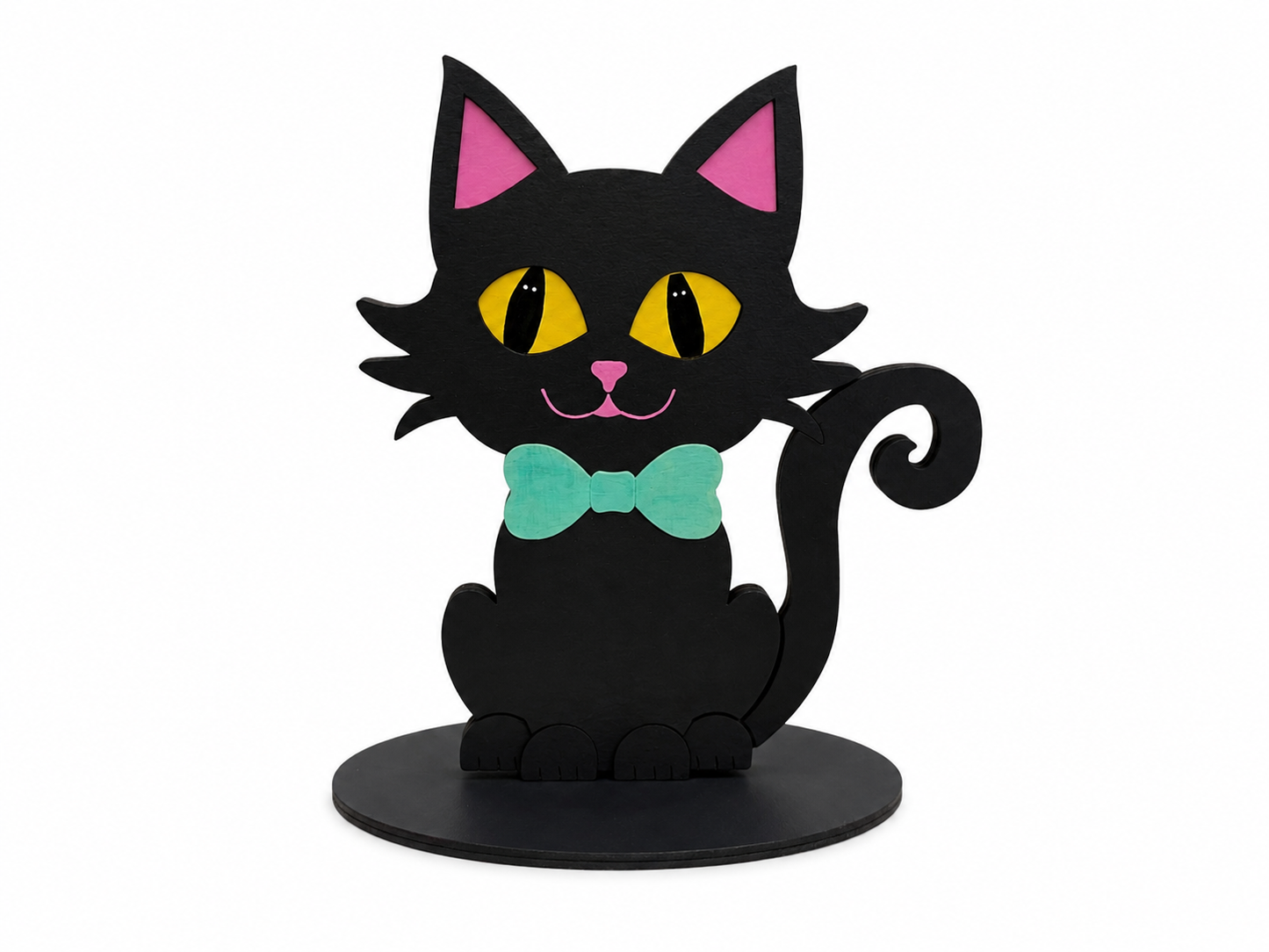 A stylized black cat figurine or sign with pink inner ears, yellow eyes, a mint green bow tie, and a black circular base, shown on a plain white background.