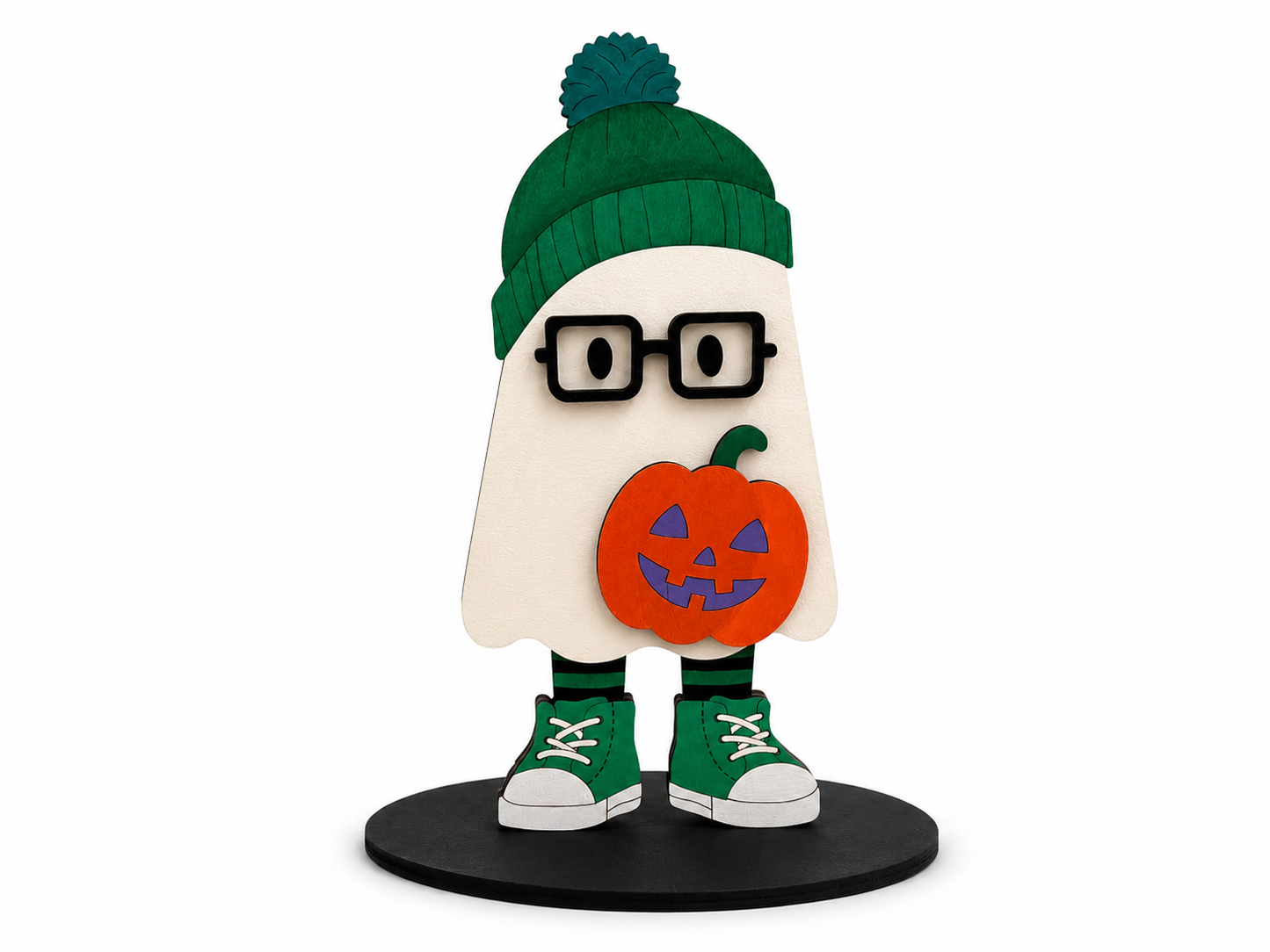 A stylized ghost-shaped figure with a green knit beanie, black glasses, green sneakers, and a carved orange pumpkin held in front, standing on a black circular base against a light gray background.