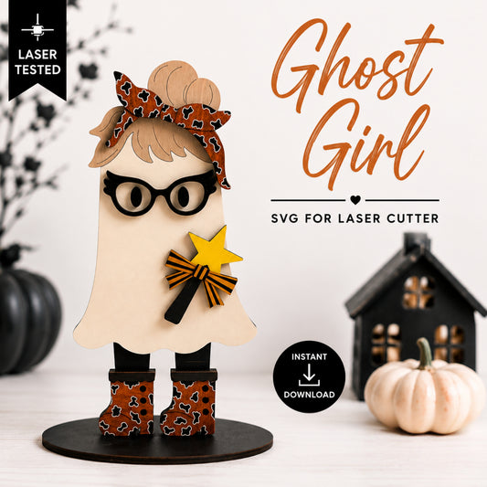 A decorative ghost-shaped figure with a leopard-print bow, black glasses, black boots, and a yellow star wand, shown on a tabletop with pumpkins and a house prop. Text reads 'Ghost Girl,' 'SVG for laser cutter,' 'Laser Tested,' and 'Instant Download.