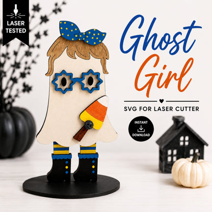 A decorative ghost-shaped figure labeled 'Ghost Girl' shown on a white background with Halloween props. The figure has a beige ghost body, blue polka-dot bow, blue star-shaped glasses, brown hair, candy corn accessory, and black boots with blue and yellow trim.