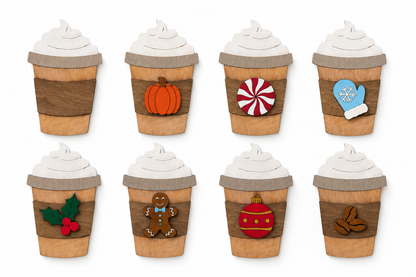 Wooden latte paint kit shown with interchangeable pumpkin, peppermint, mitten, holly, gingerbread, ornament, and coffee bean accents.