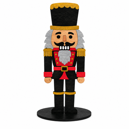 A stylized wooden nutcracker figurine standing on a round black base, with a black hat trimmed in gold, a red coat with gold buttons, gray hair and beard, and black pants, photographed on a plain white background.