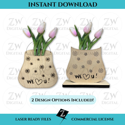 Digital listing image displaying two wooden laser-cut vases with engraved “We ❤️ U!” messages and flower doodles, each holding real pink tulips. One vase design includes a hanging wire; the other rests on a rectangular base. Text reads “Instant Download,” “2 Design Options Included,” and “Laser Ready Files - Commercial License.”