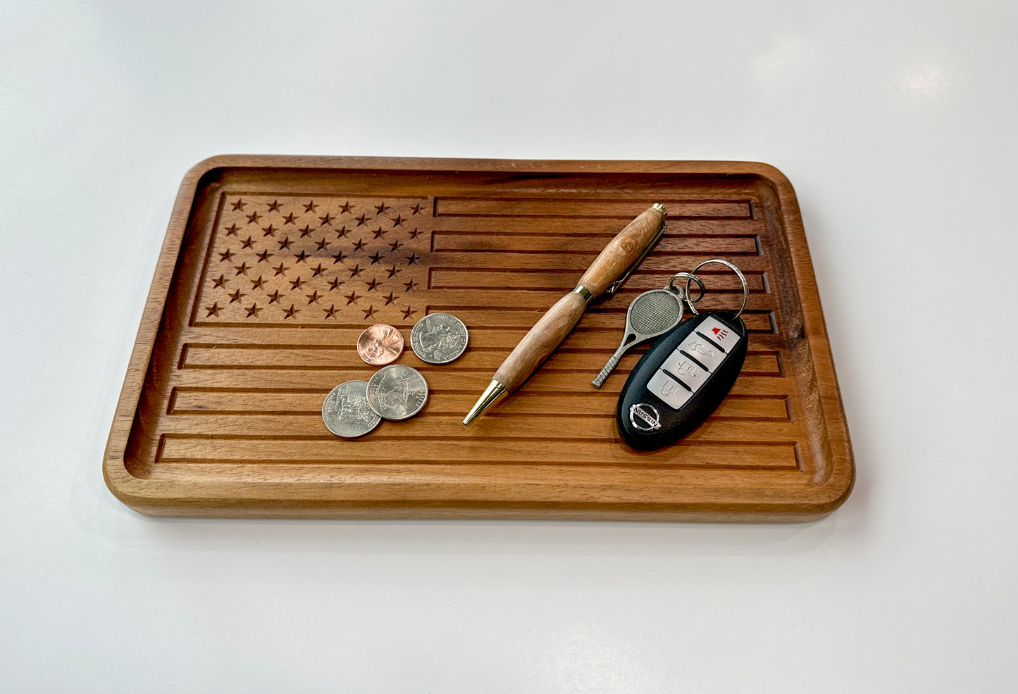 An example of how the American Flag Catch All Tray can be used by holding items such as coins, pen, and keys.