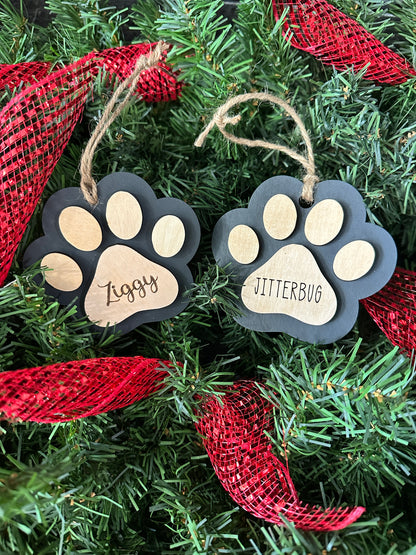 Handmade, wooden ornament Christmas gift for the pet lovers in your life - Black ornament with light colored wood paw details and customized with engraved name.