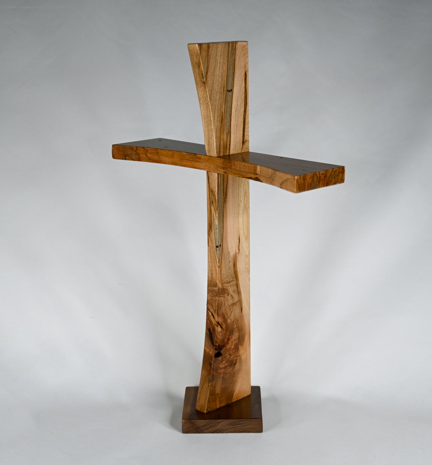 Ambrosia Maple Modern Cross with a unique wood pattern.