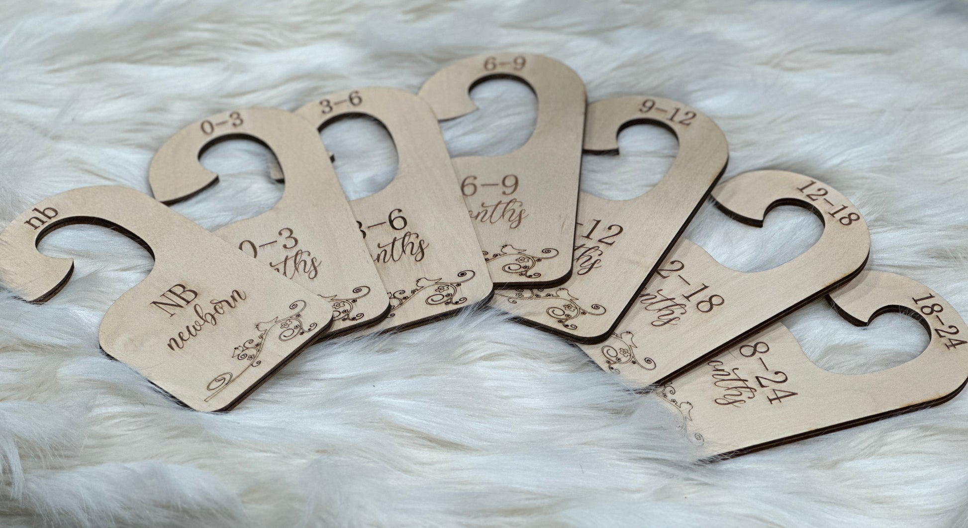 A custom wood gift for new mom. Seven baby clothes organizers to label baby clothe from Newborn to 24 months.