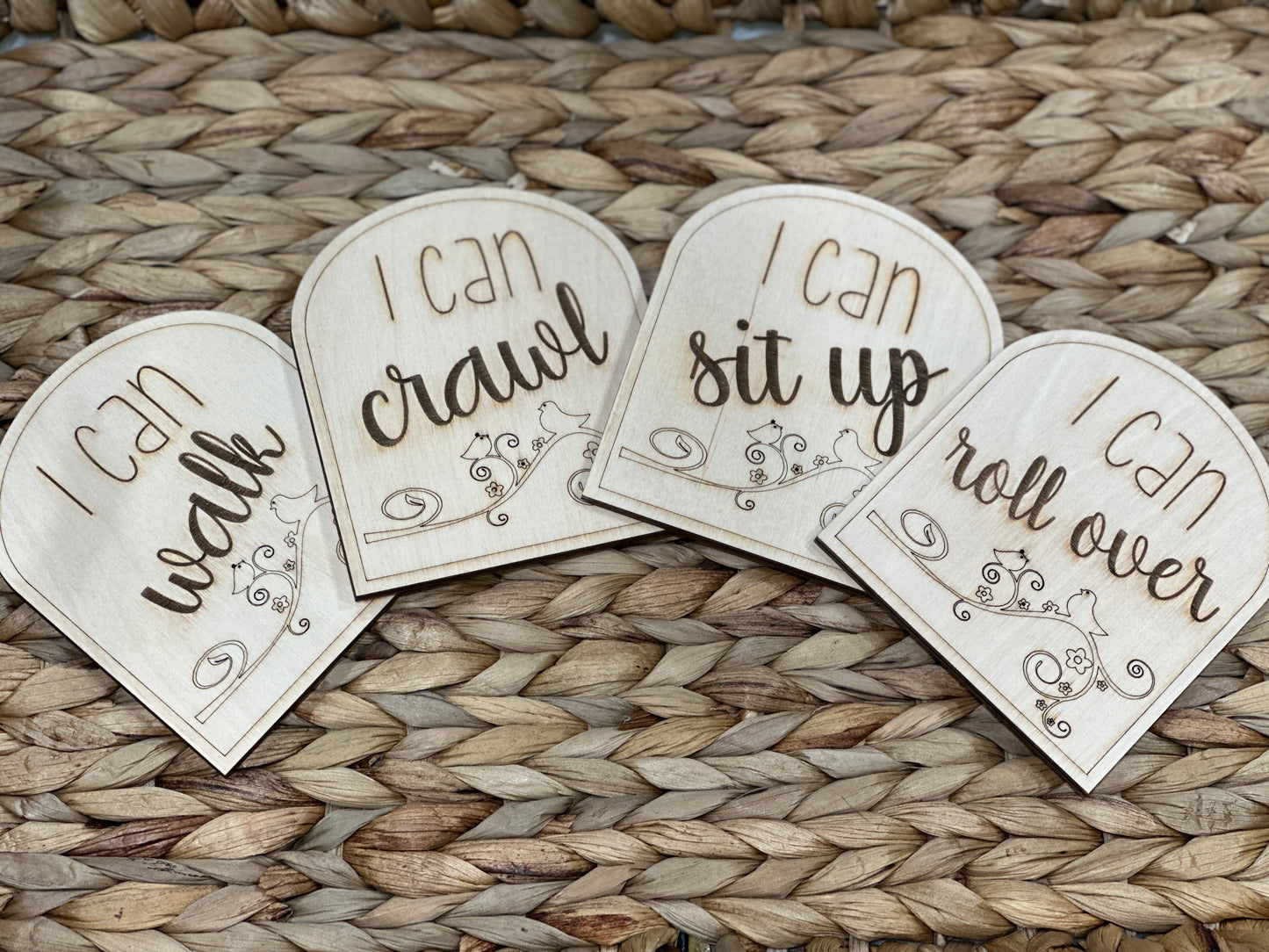 Four milestone cards for babies made out of wood.