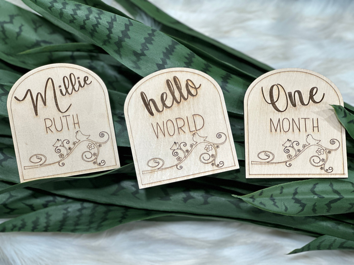 Personalized wood signs for new baby featuring baby's name and "hello world."