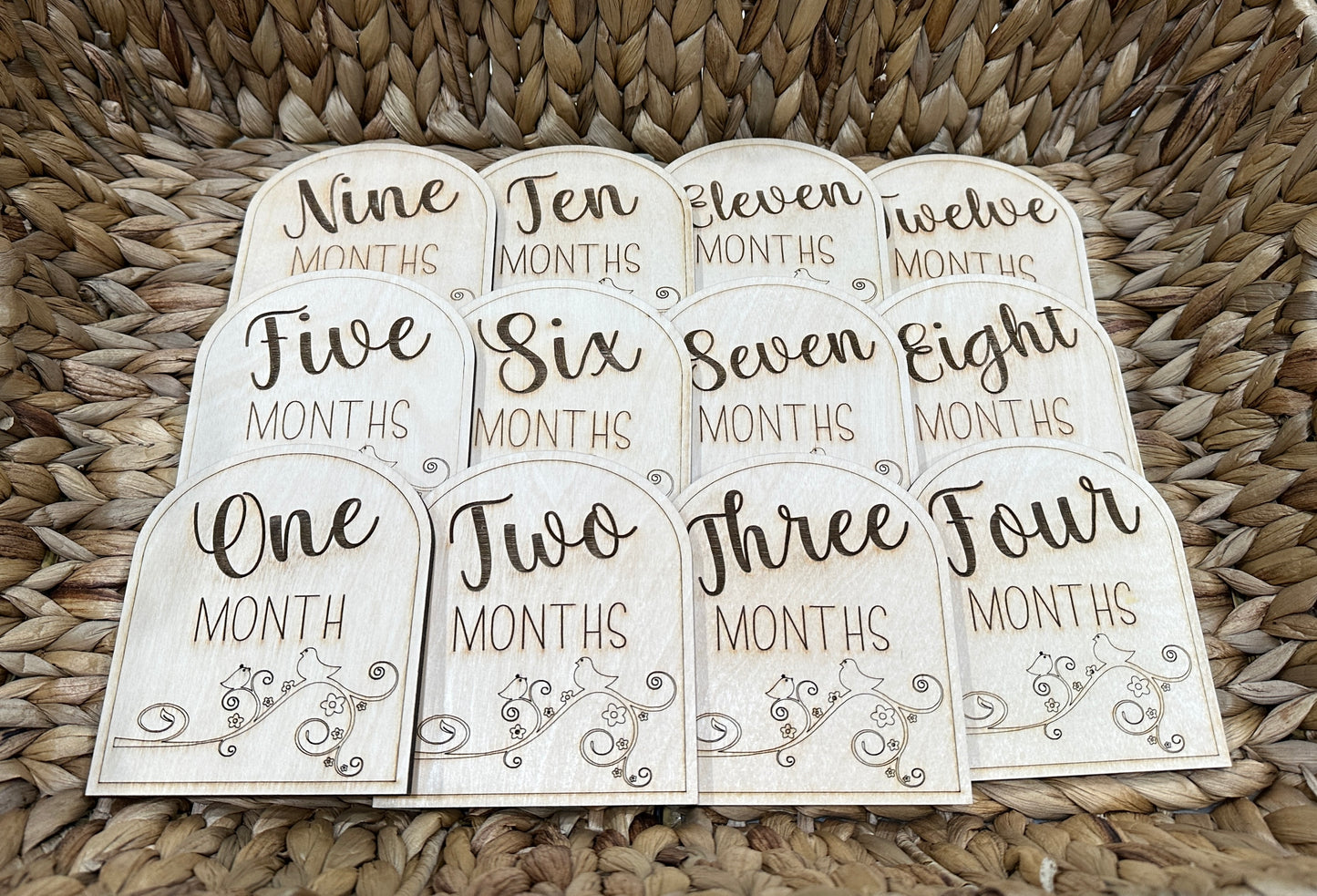 Handmade wooden baby milestone cards for ages one - twelve months.