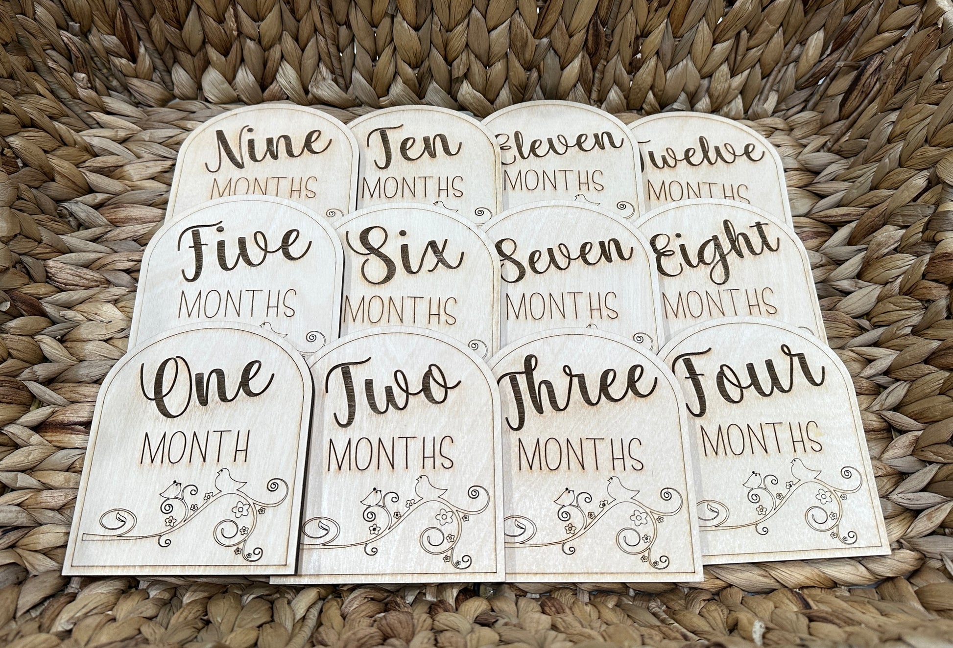 Handmade wooden baby milestone cards for ages one - twelve months.