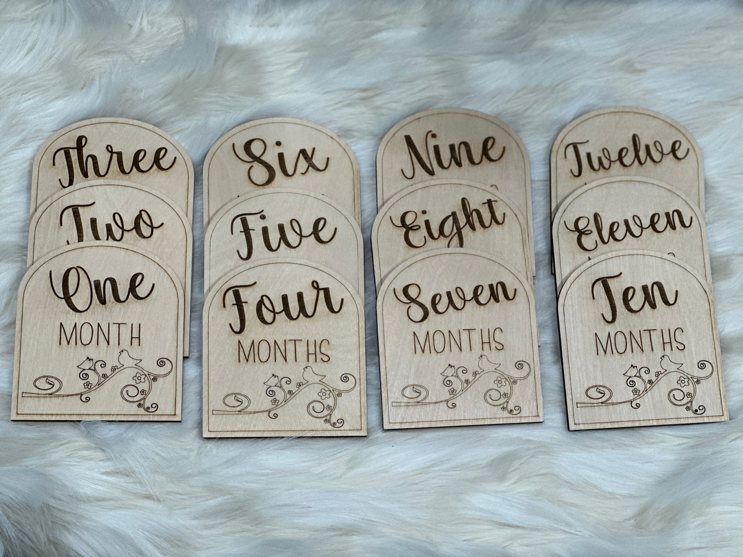 Wooden age cards for baby featuring ages one month - 12 months.