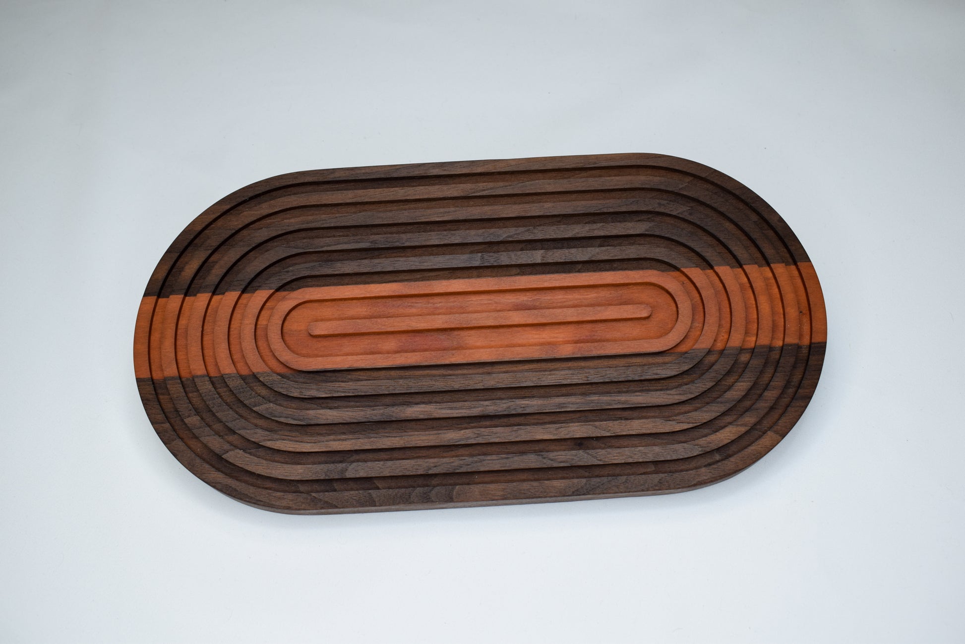 Handmade woodworking gift and decor for home. A Walnut and Cherry bread board trivet.