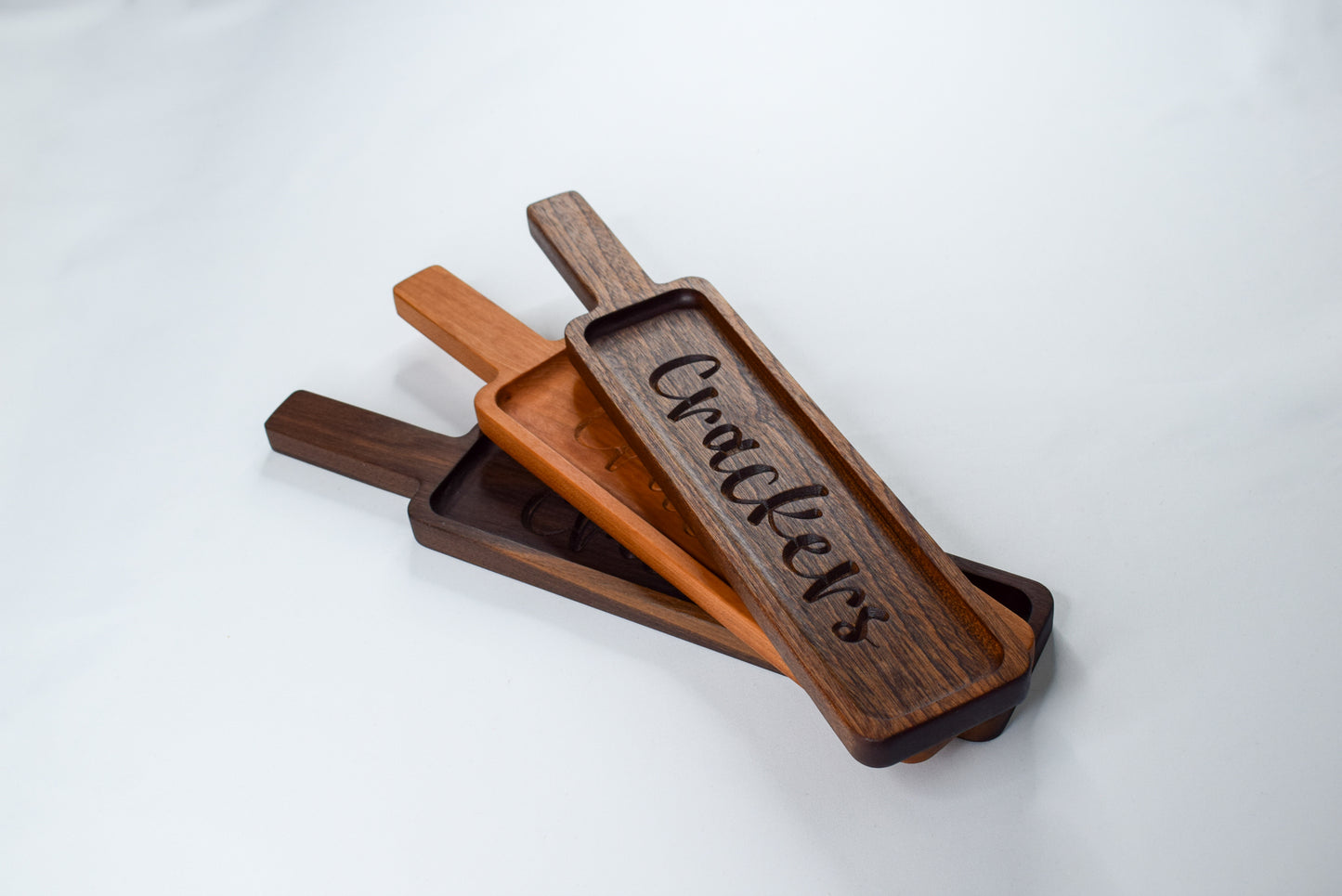 Custom laser engraved cracker trays made out of Mahogany, Cherry, or Walnut wood.