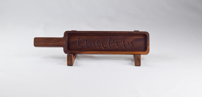 Walnut wood cracker tray that is laser engraved with the word "crackers."