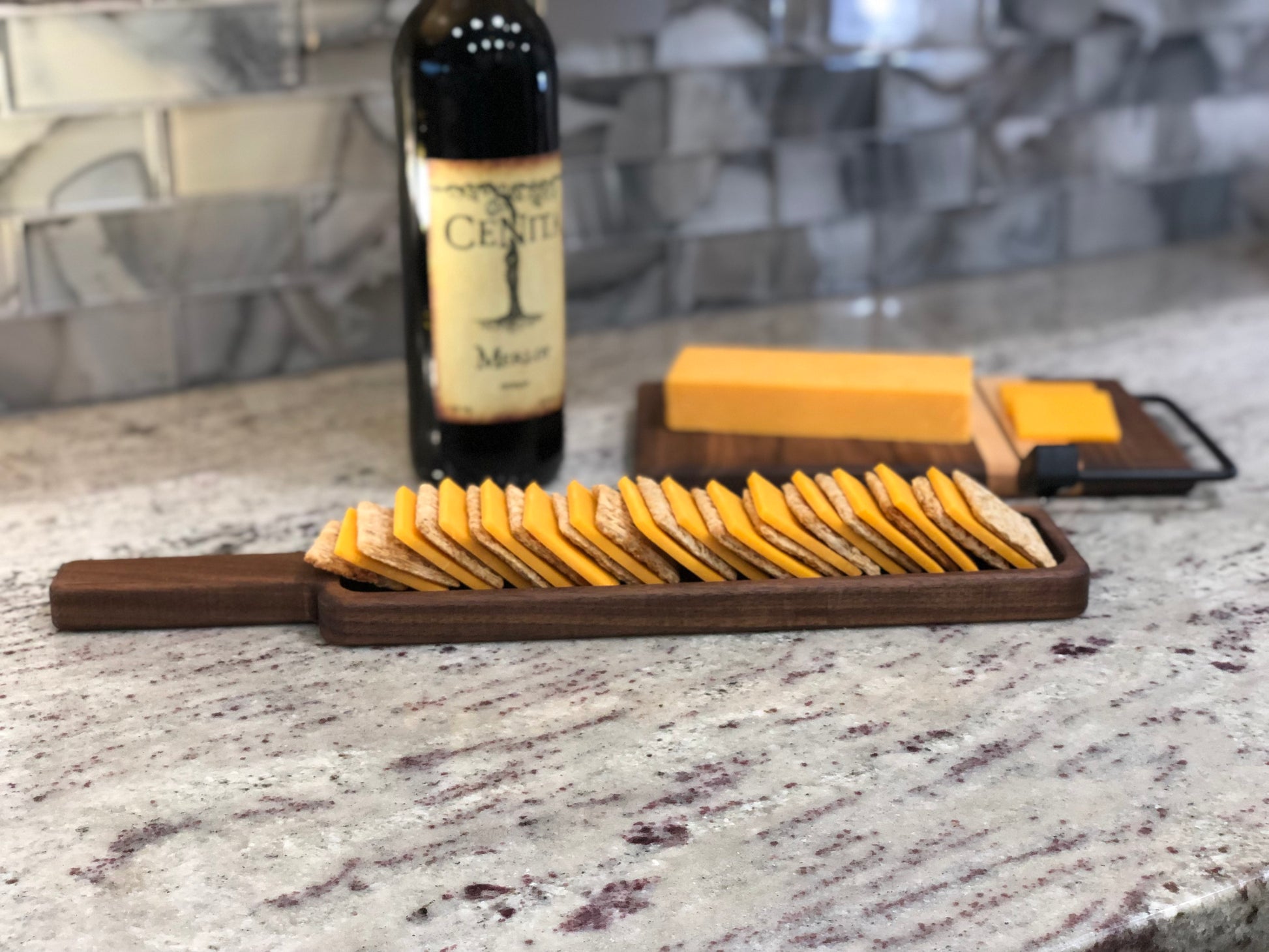 Handmade wood cracker tray displayed with cheese and crackers.