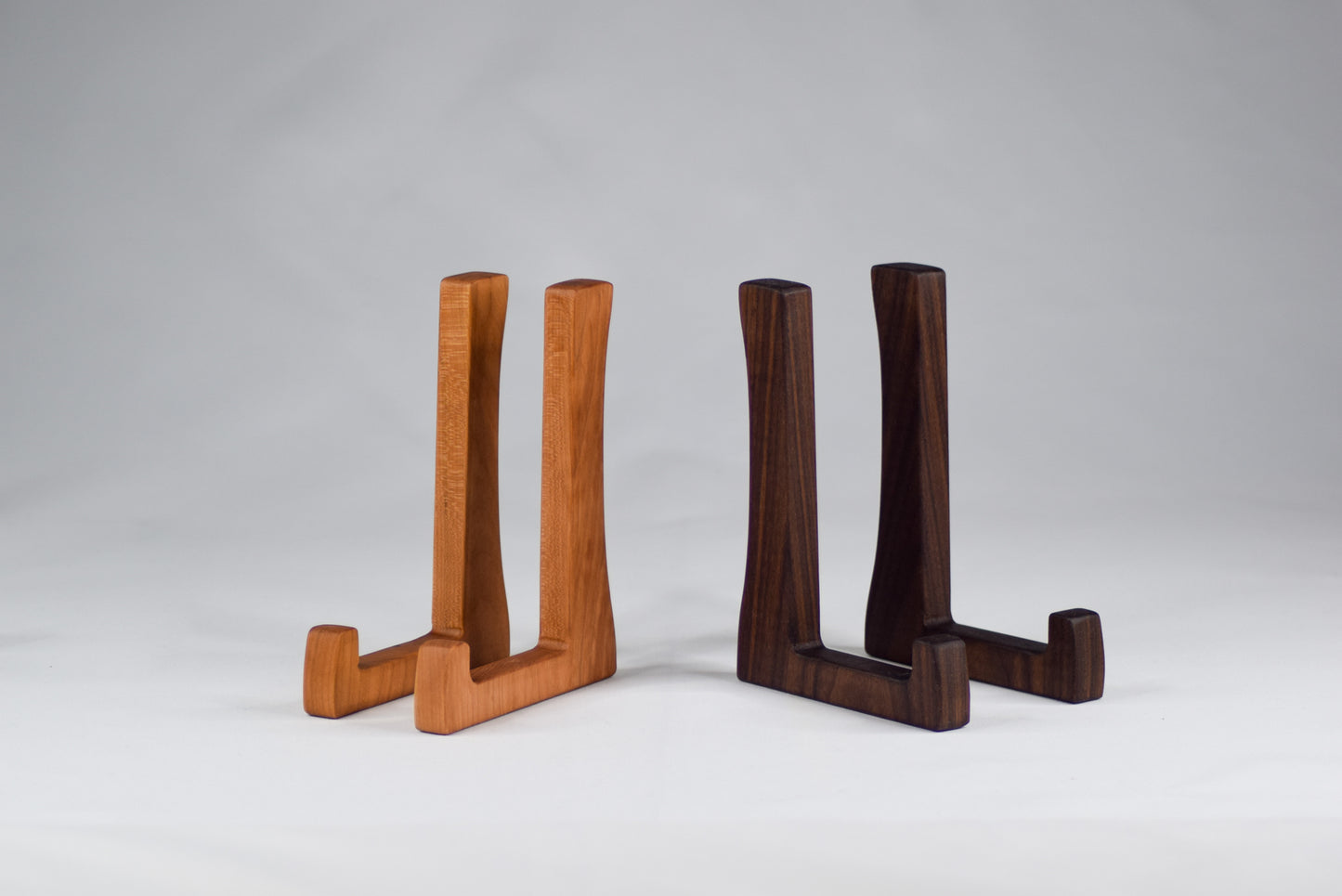 A display of two tall cutting board stands. These stands are used to help promote even air flow around your handmade cutting boards to help reduce warping.