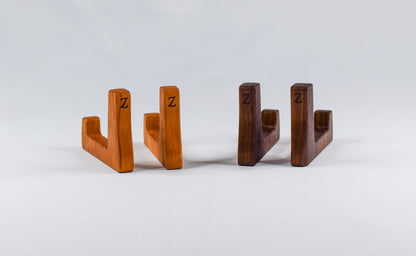 A display of two short cutting board stands made of cherry and walnut wood.