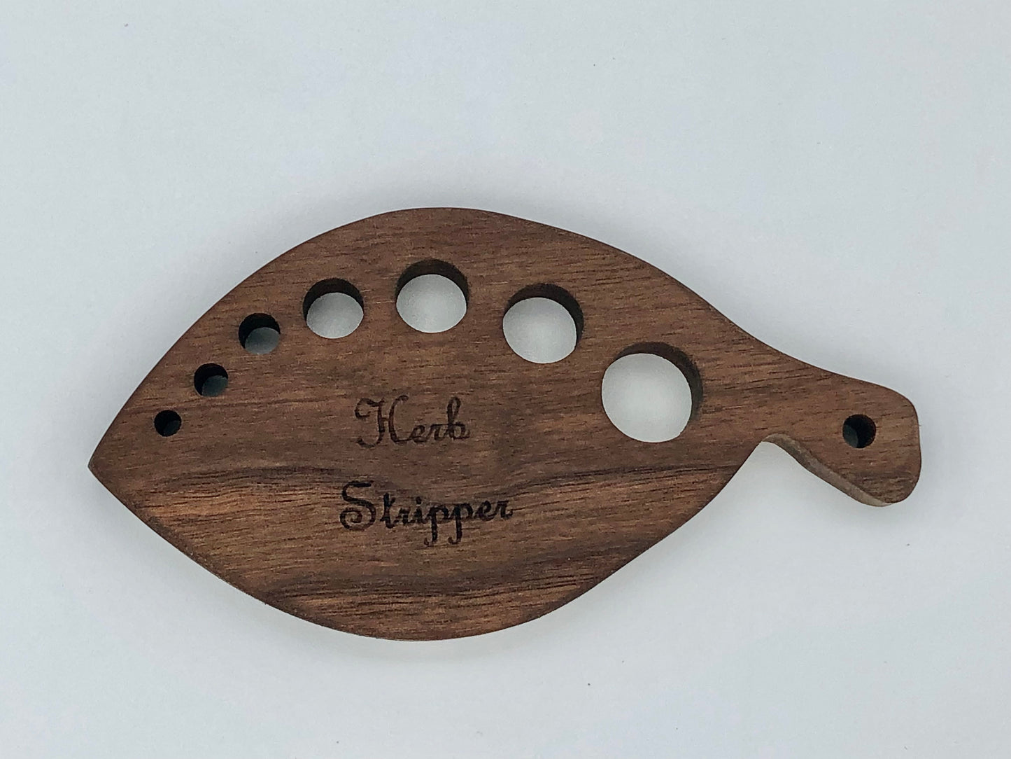 Walnut wood herb stripper featuring 7 different sized holes. Handmade locally in Georgia.