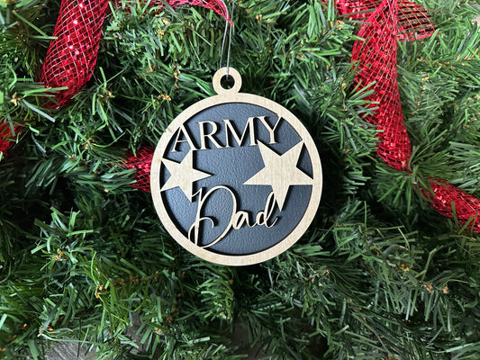 Military Christmas ornament that reads "Army Dad." A black wood ornament with light birchwood words on top.