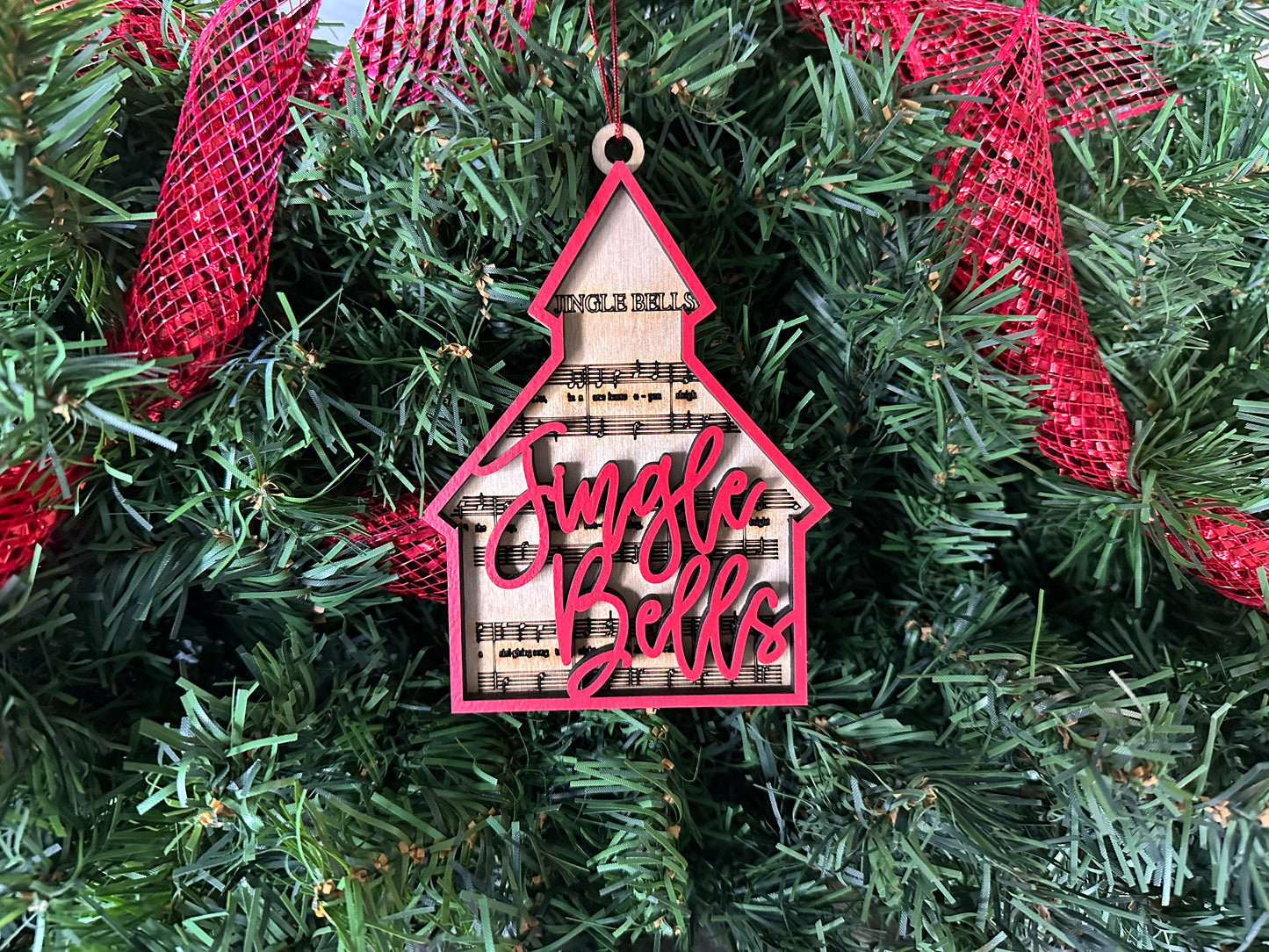 Woodworking gift ornament. Red font and Red chapel shape with Jingle Bells lyrics.