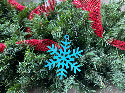 A unique blue-colored, laser cut snowflake ornament, locally made in Georgia with Birchwood.