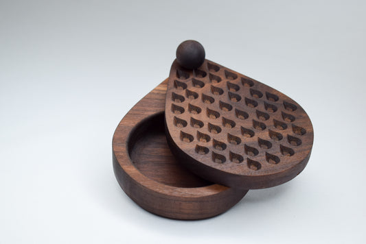 Handcrafted salt cellar with dark walnut wood and engraved rain drop detailing.