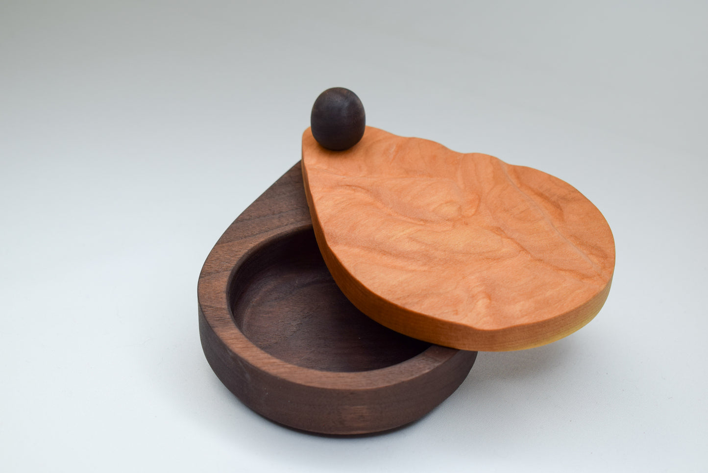 Locally handmade salt cellar with a smooth wave engraved design in the cherry wood lid.