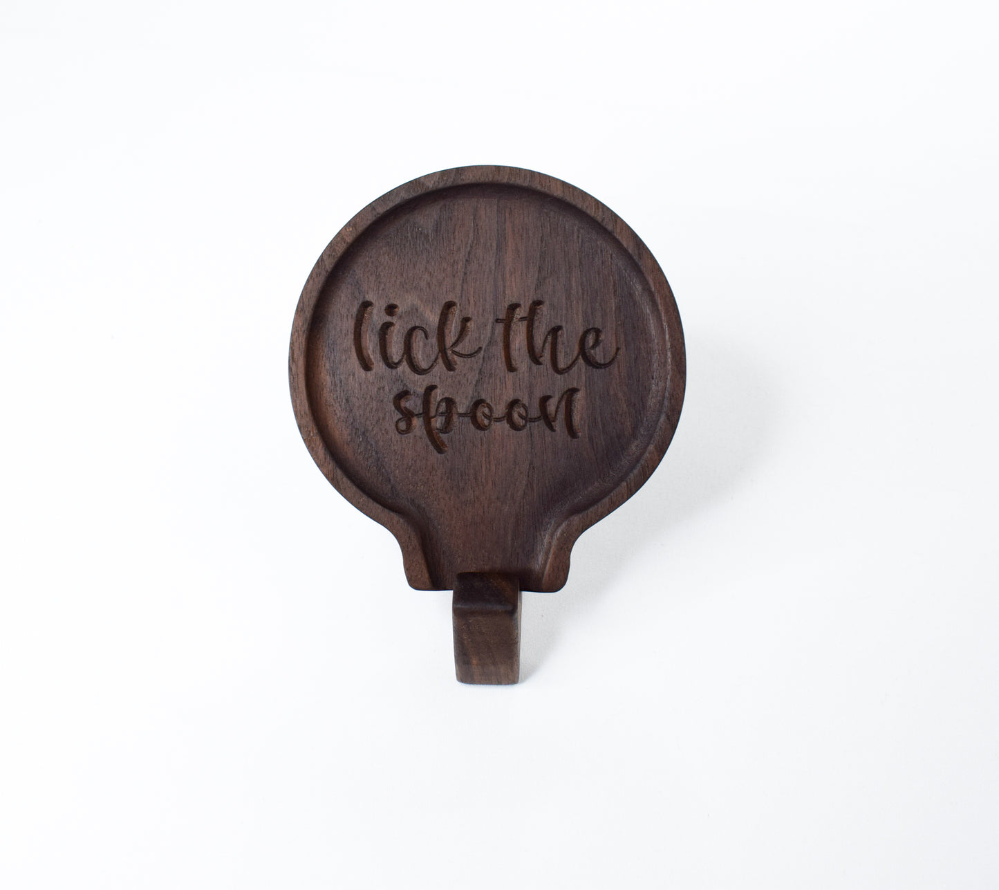 A fun gift idea for those who love to cook - a handmade wooden spoon rest with the saying "lick the spoon"