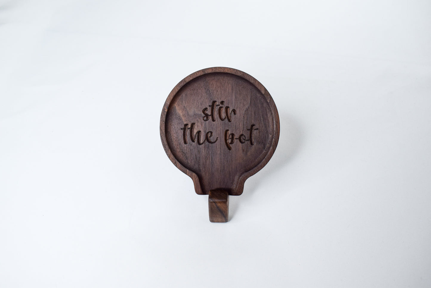 A fun gift idea for those who love to cook - a handmade wooden spoon rest with the saying "stir the pot"