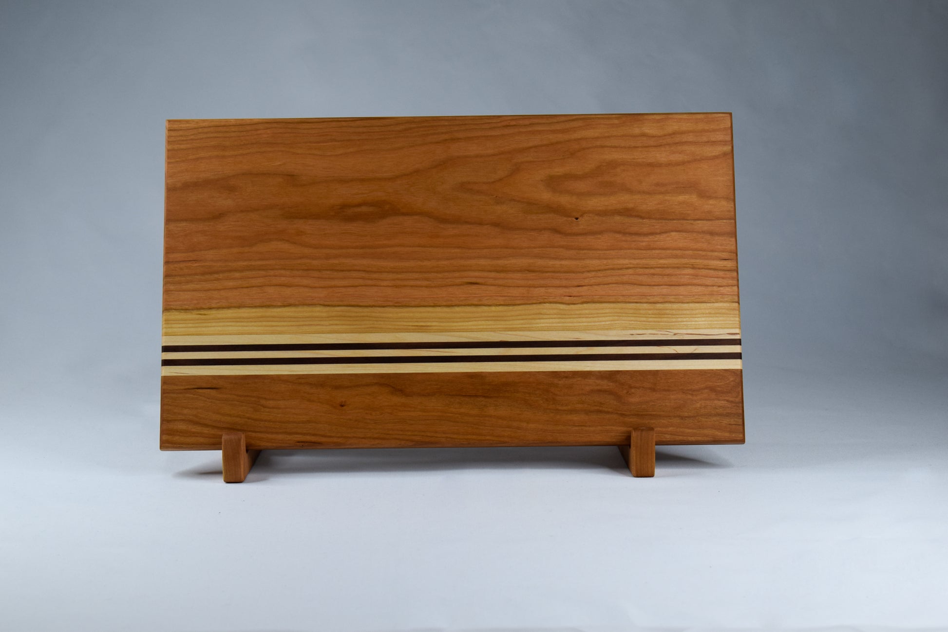 Front view of the striped cutting board - handmade woodworking gift for those who love to cook.