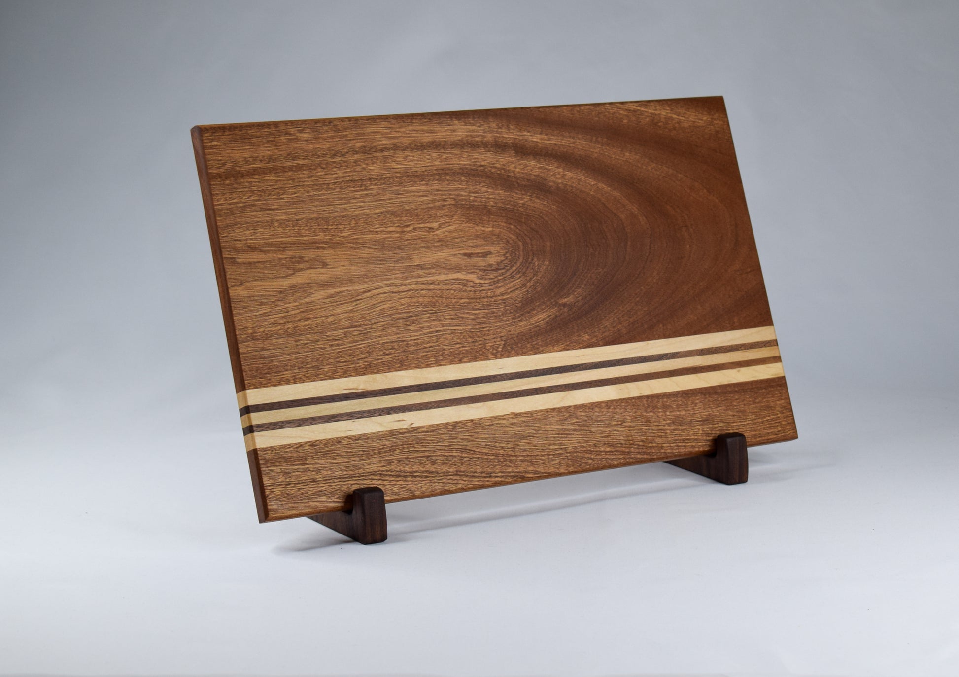 Handmade woodwork gift for the cook in your life. Sapele, Maple, and Walnut striped cutting baord.