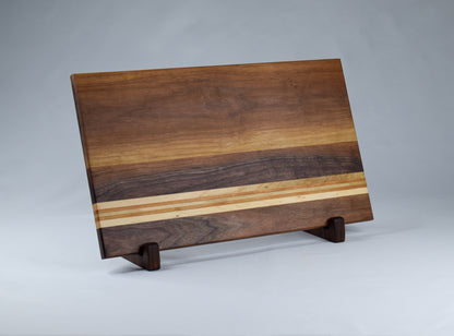 Handcrafted wood gift for the cook in your life. Walnut, Maple, and Cherry wood striped cutting board.