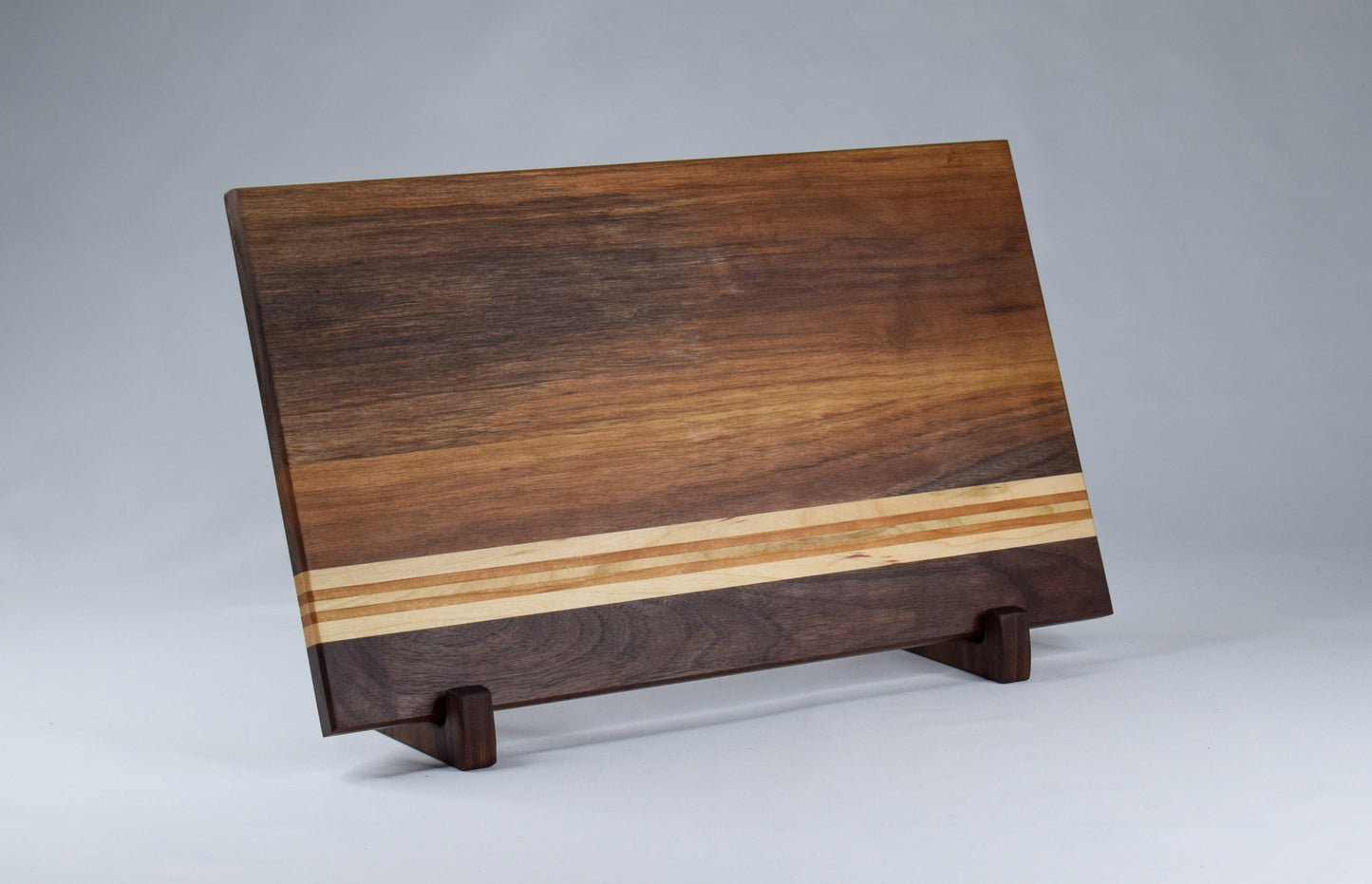 Unique handmade wood serving tray and cutting board. Featuring maple and cherry hardwood stripes against a walnut backdrop.