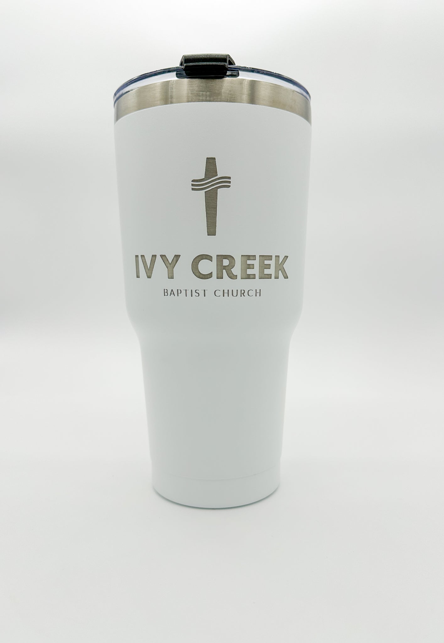 White tumbler with business name custom engraved on it. Includes BPA free lid.