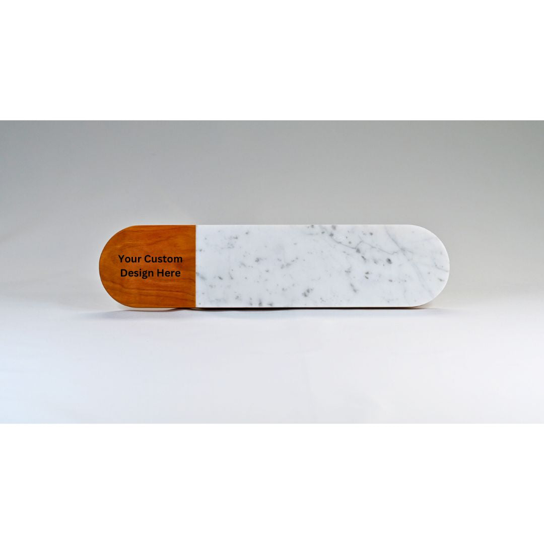 A long oval shaped serving tray with marble and wood, with the option to add a custom engraved design.
