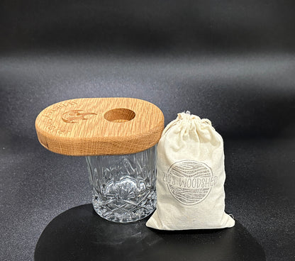 Zig's woodshed whiskey smoker with a small bag of wood chips to add smoky flavor to whiskey drink.