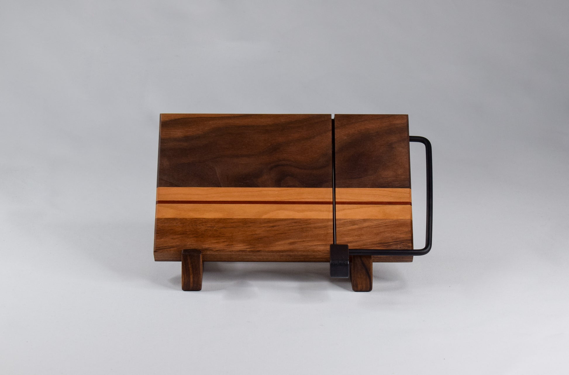 Handmade wood gift. Wooden cheese cutter made of walnut, cherry, and padauk wood.