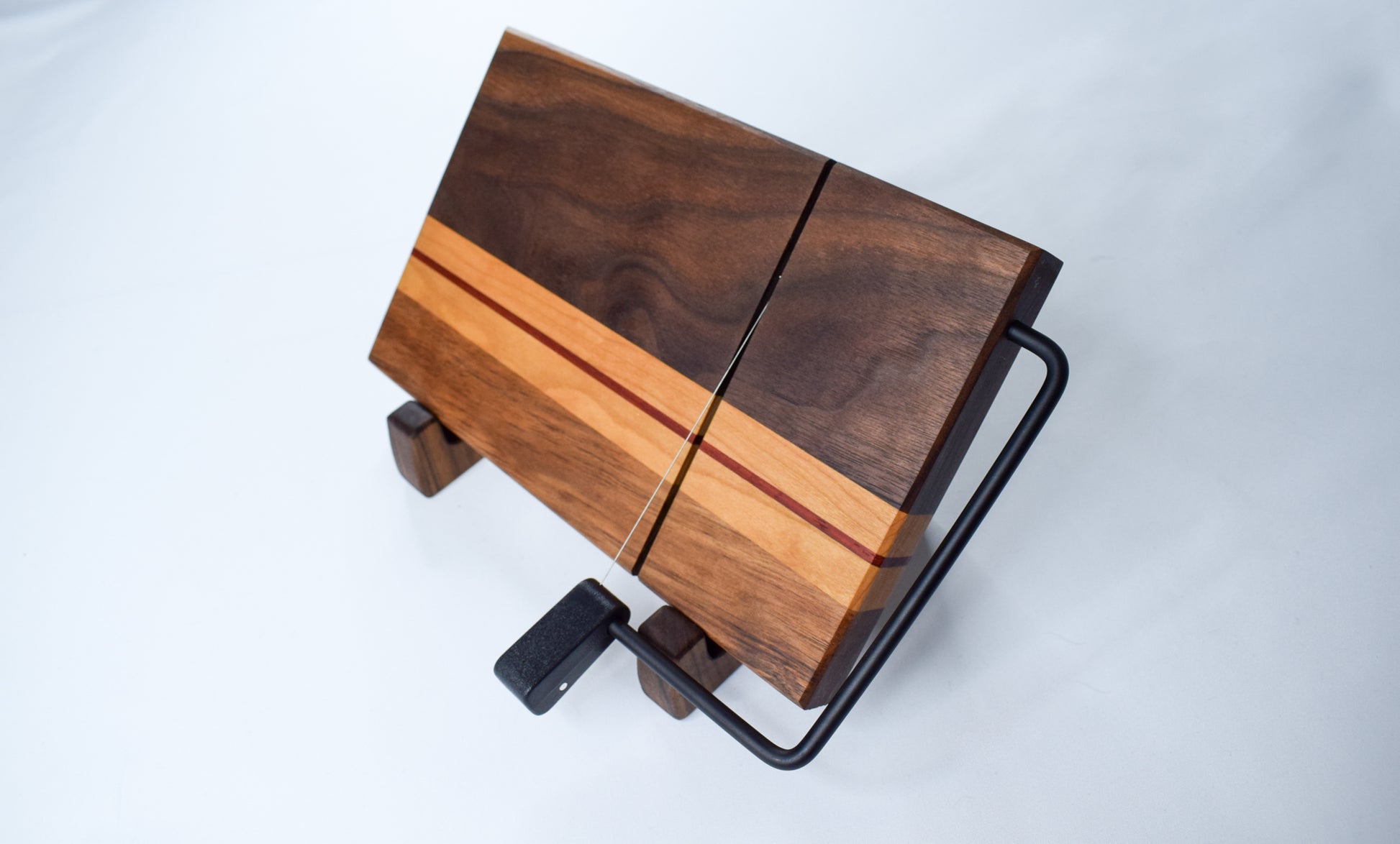 Handmade wood cheese board and slicer. Made of locally sourced walnut, maple, and padauk hardwoods and handmade in our workshop in GA.