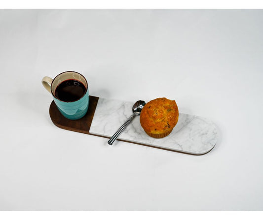 Handmade serving board made of Italian marble and domestic hard wood. Displayed with coffee and a muffin.