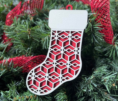 Red wooden Christmas stocking, with light colored design over top.