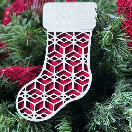 Handmade wooden Christmas decor - a beautiful laser cut design on a red wooden stocking.