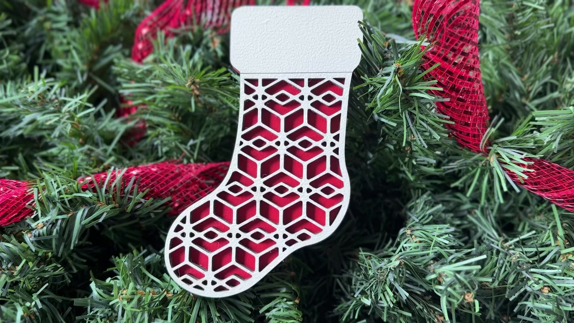 Handmade wooden Christmas decor - a beautiful laser cut design on a red wooden stocking.